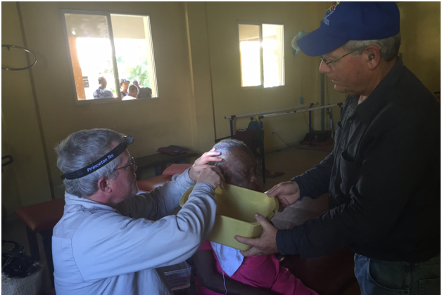 Kurt Chappell removes ear wax prior to fitting 82-year-old fitted with hearing aids